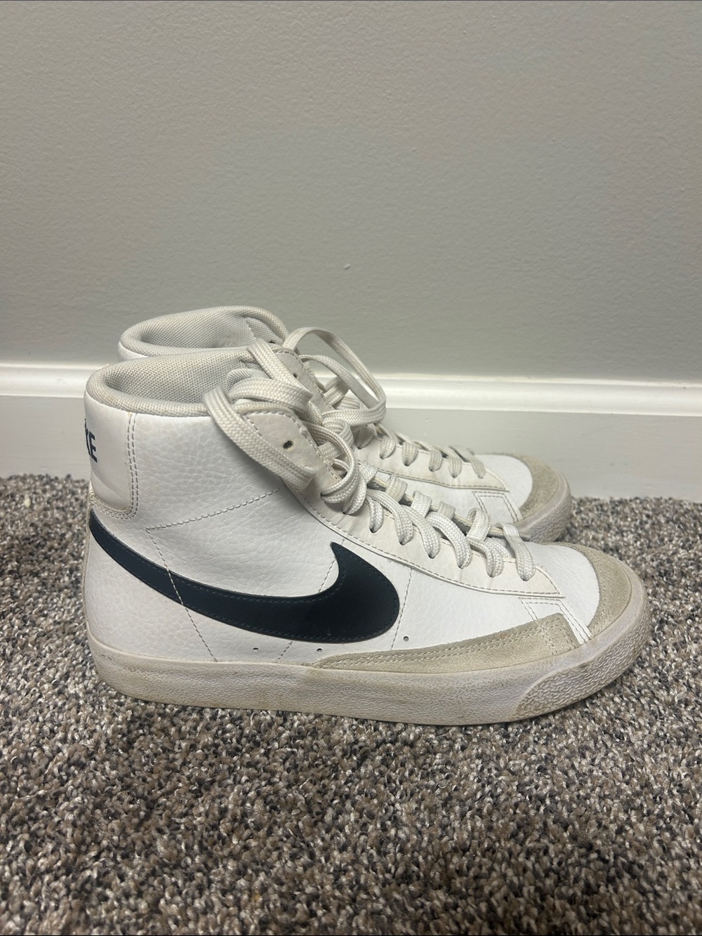 Nike White High-Top Sneakers with Black Swoosh